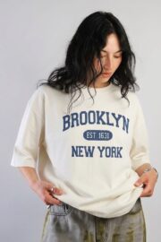 Off-white oversized long sleeve T-shirt featuring a Brooklyn New York graphic print on the front, crafted from soft premium cotton for everyday comfort.
