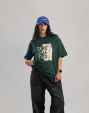 Dark green oversized graphic T-shirt featuring a "ZERO ONE TWO" front print with illustrated artwork and a soft cotton fabric.